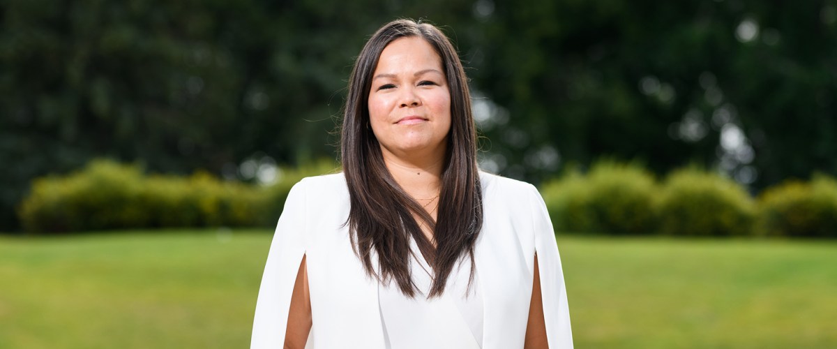 Photo of Jessica Dumas outdoors in front of lawn and trees